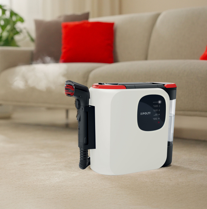 Polti StainOver spot cleaner near a sofa